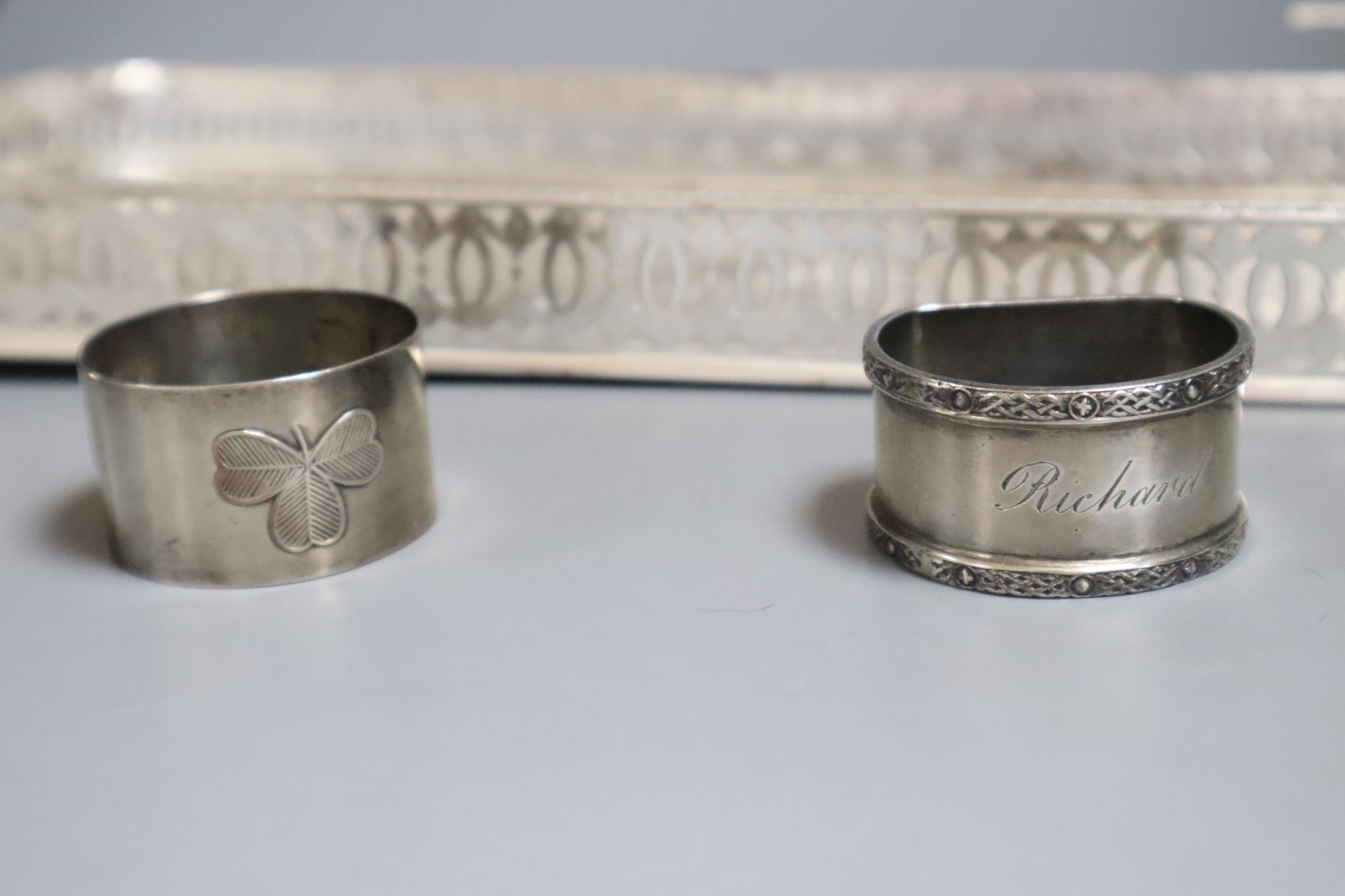 A plated tray, a pair of silver dwarf candlesticks and two napkin rings